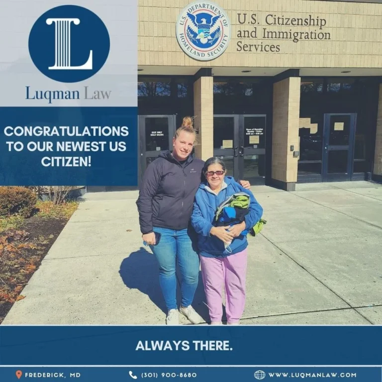 Two women smiling and standing in front of the U.S. Citizenship and Immigration Services building, with congratulatory text from Luqman Law celebrating the newest US citizen.