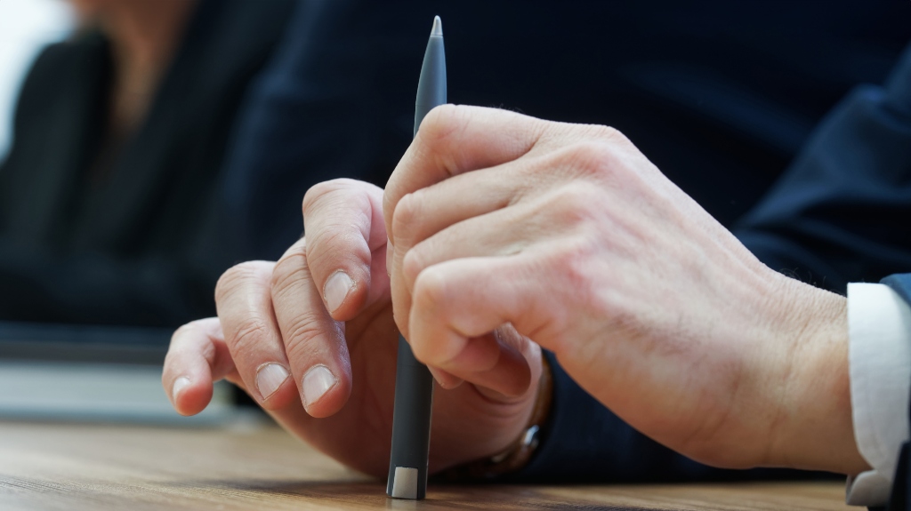 A man holds a fountain pen